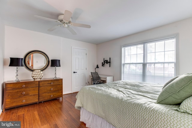 bedroom featuring ceiling fan and dark hardwood / wood-style floors