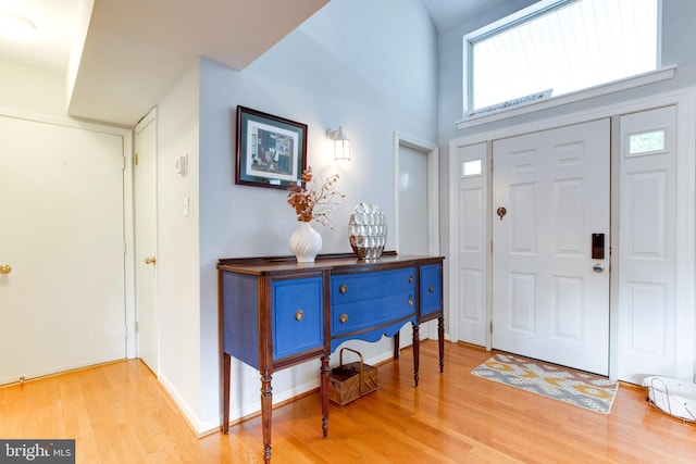 foyer featuring a high ceiling and light hardwood / wood-style floors