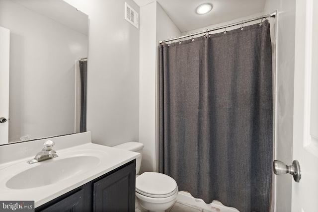 bathroom featuring toilet and vanity