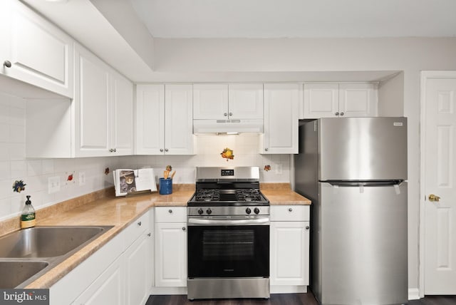 kitchen featuring decorative backsplash, sink, white cabinets, and stainless steel appliances