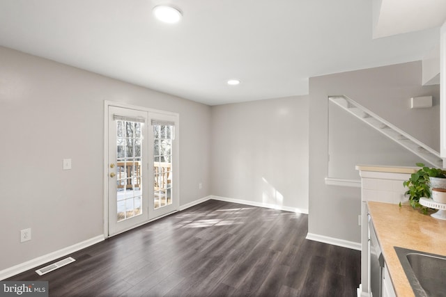 unfurnished living room with dark wood-type flooring