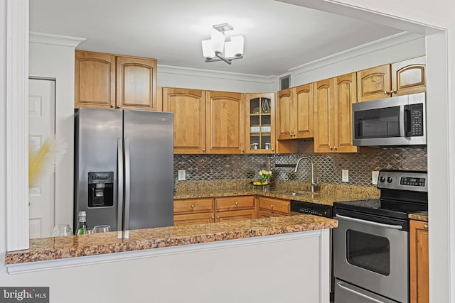 kitchen with backsplash, an inviting chandelier, sink, stone countertops, and stainless steel appliances