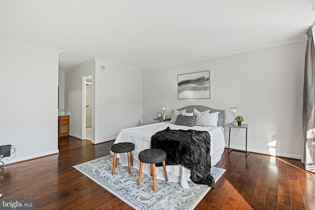 bedroom featuring ornamental molding, ensuite bath, and dark wood-type flooring