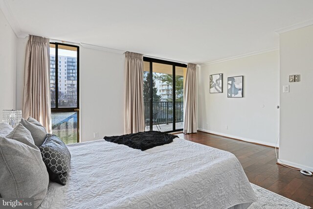 bedroom featuring access to exterior, dark hardwood / wood-style floors, floor to ceiling windows, and multiple windows