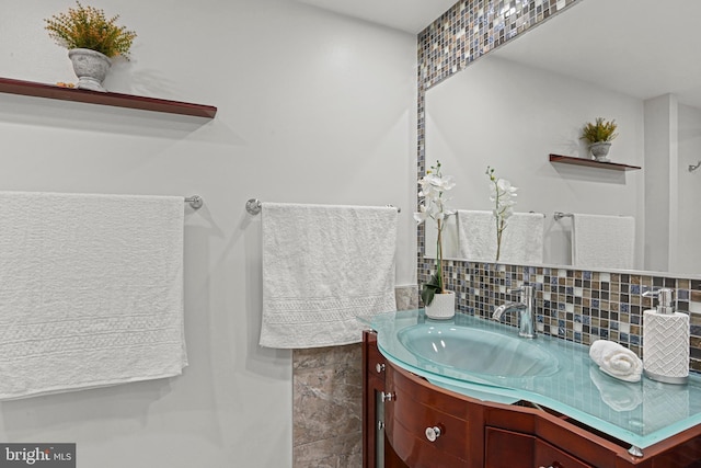 bathroom with tasteful backsplash and vanity