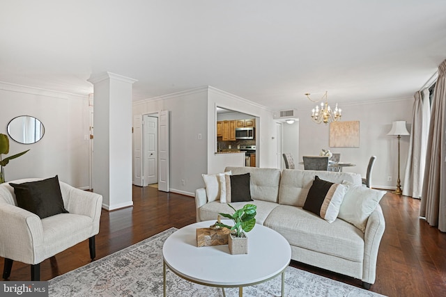 living room with dark hardwood / wood-style flooring, ornamental molding, and a chandelier