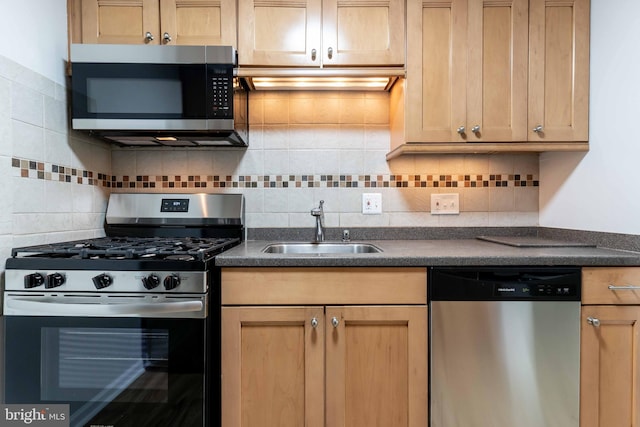 kitchen with extractor fan, sink, appliances with stainless steel finishes, and tasteful backsplash