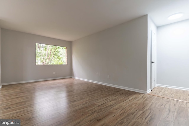 empty room with hardwood / wood-style floors