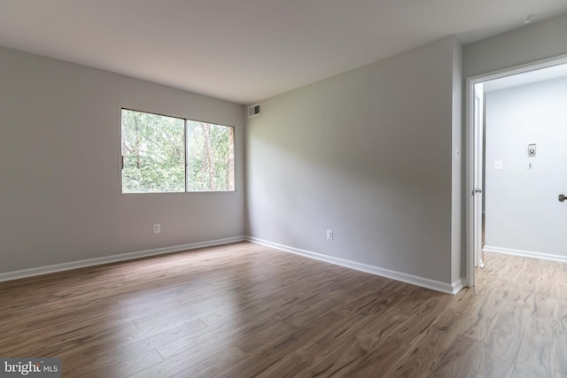 empty room with hardwood / wood-style flooring