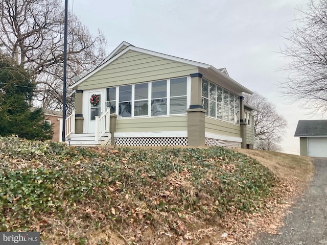 view of front of property featuring a sunroom