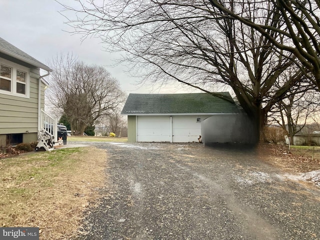 view of home's exterior with a garage and an outdoor structure