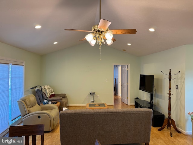 living room with ceiling fan, light hardwood / wood-style floors, and lofted ceiling