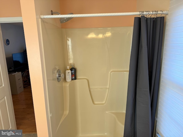 bathroom featuring wood-type flooring and walk in shower