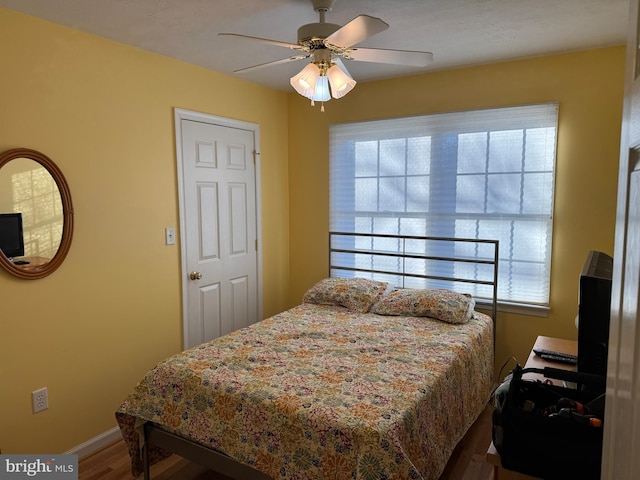 bedroom featuring ceiling fan and hardwood / wood-style floors