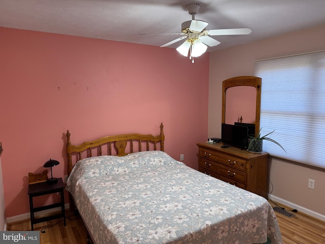 bedroom with hardwood / wood-style flooring and ceiling fan