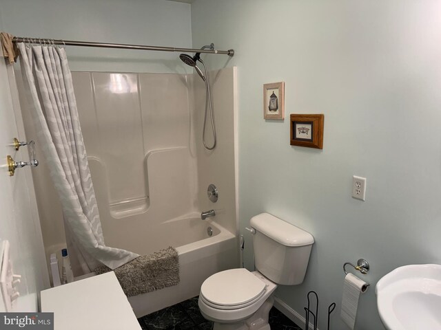 bathroom featuring shower / bath combination with curtain and toilet