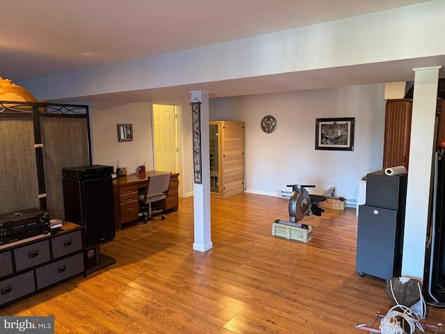 workout area with light hardwood / wood-style floors