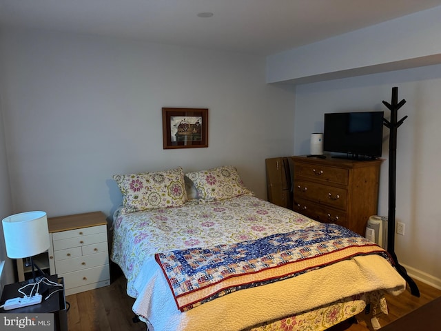 bedroom with dark wood-type flooring