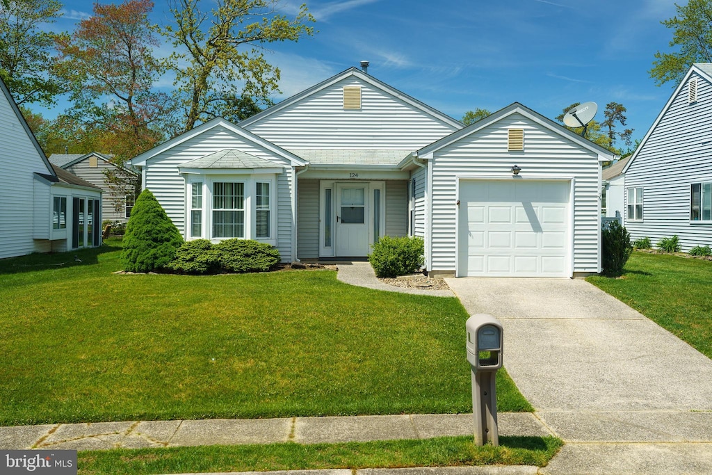 ranch-style home featuring a front yard and a garage