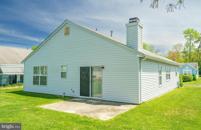 back of property with a yard and a patio area