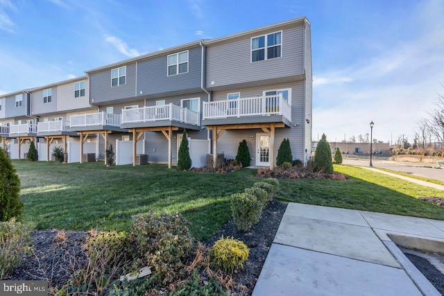 rear view of property with central AC, a yard, and a deck