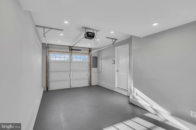 garage with electric panel and a garage door opener