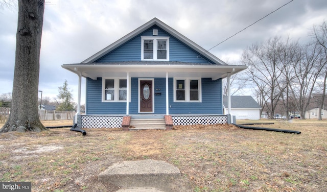 bungalow featuring a front yard and covered porch