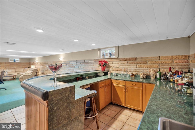 kitchen featuring wood ceiling, plenty of natural light, kitchen peninsula, and light tile patterned floors