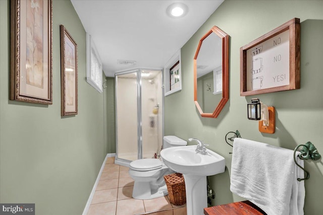 bathroom featuring toilet, tile patterned floors, an enclosed shower, and sink