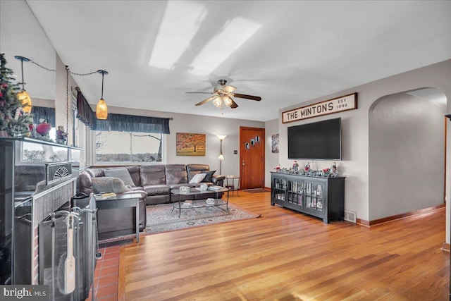 living room featuring ceiling fan and wood-type flooring