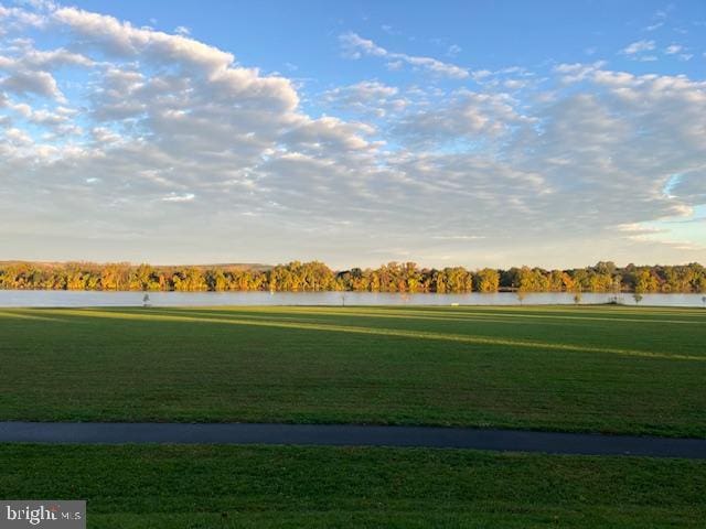 view of community with a lawn and a water view