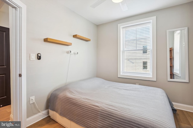 bedroom with ceiling fan and light hardwood / wood-style floors