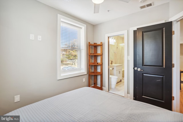 bedroom featuring ensuite bath and ceiling fan