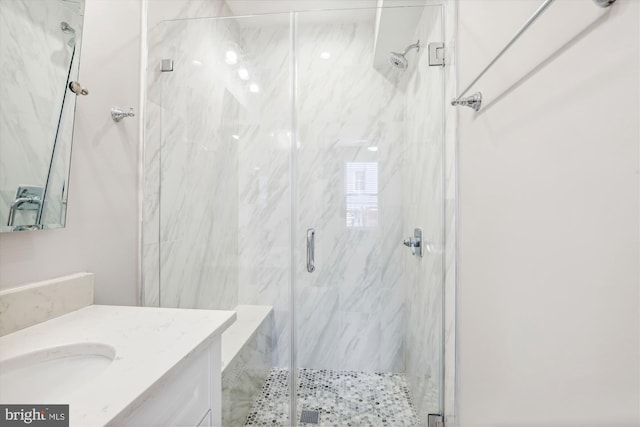 bathroom with vanity and a shower with door