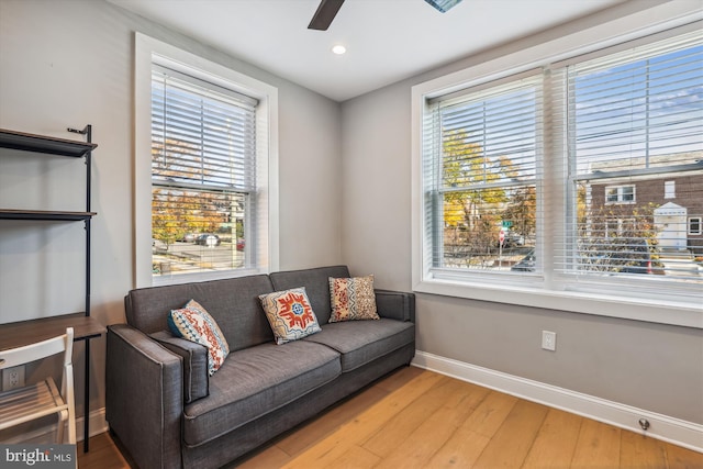 sitting room featuring ceiling fan, plenty of natural light, and light hardwood / wood-style floors