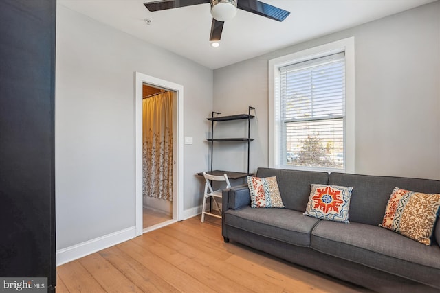 living room featuring ceiling fan and hardwood / wood-style floors