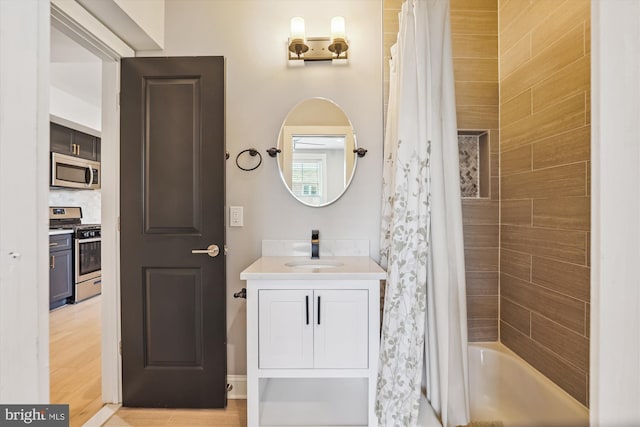 bathroom with vanity, tasteful backsplash, and shower / tub combo with curtain