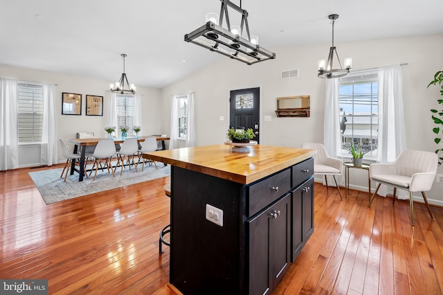 kitchen featuring a kitchen island, a chandelier, and pendant lighting