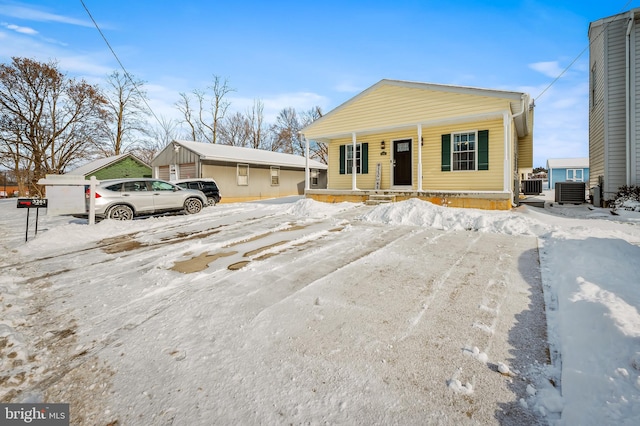 view of front of home with cooling unit and a porch