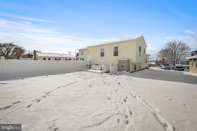 view of snow covered rear of property