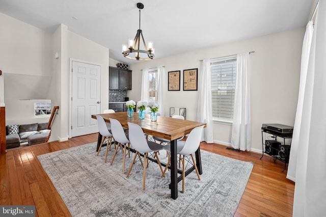 dining space featuring a chandelier and light hardwood / wood-style flooring