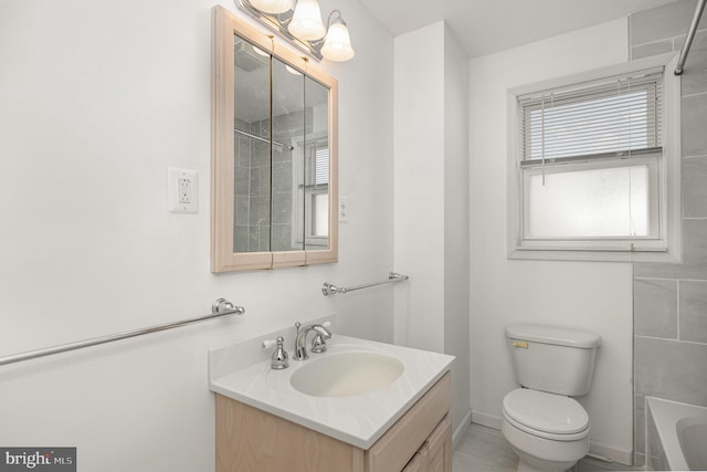 full bathroom featuring tiled shower / bath, tile patterned flooring, vanity, and toilet