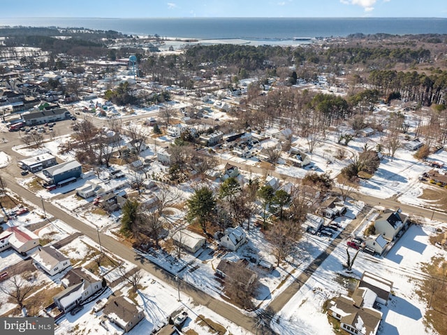 snowy aerial view featuring a water view