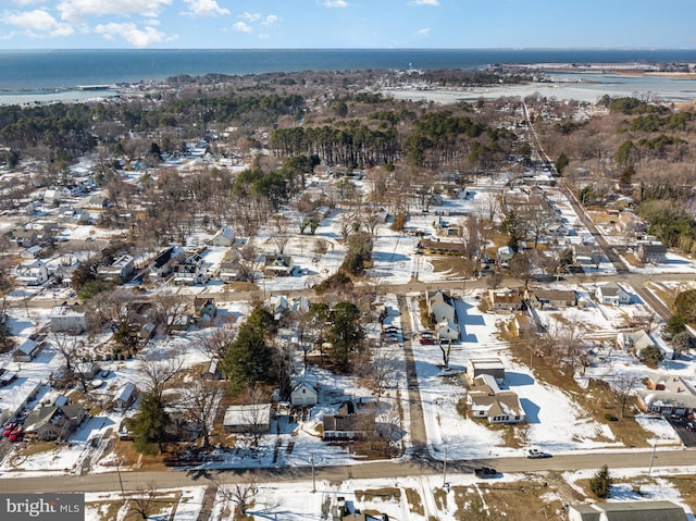 snowy aerial view featuring a water view