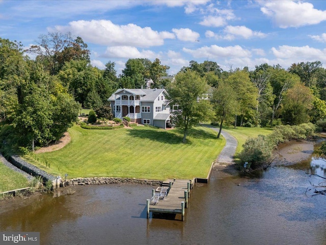 back of house featuring a lawn, a water view, and a balcony