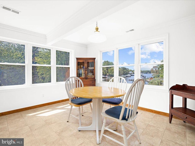 dining room featuring beam ceiling and crown molding