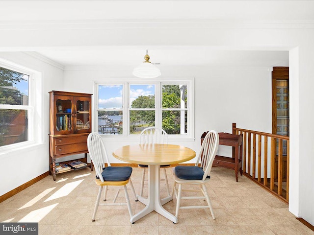 dining space with crown molding