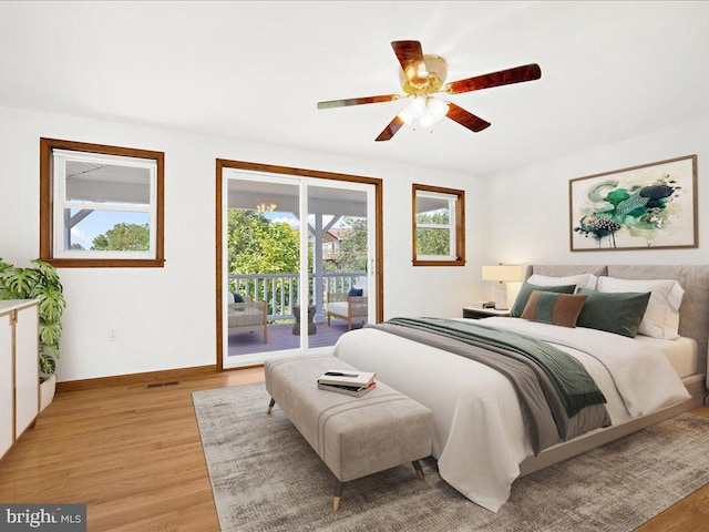 bedroom featuring access to exterior, light wood-type flooring, and ceiling fan