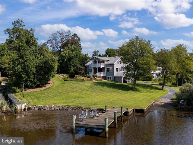 view of dock with a yard, a balcony, and a water view