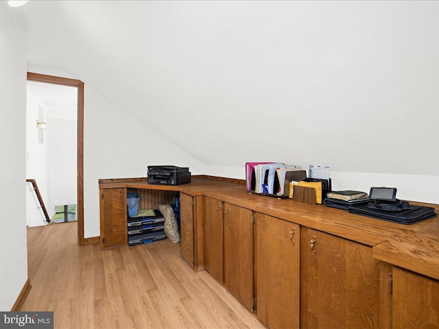 office with light hardwood / wood-style floors and lofted ceiling